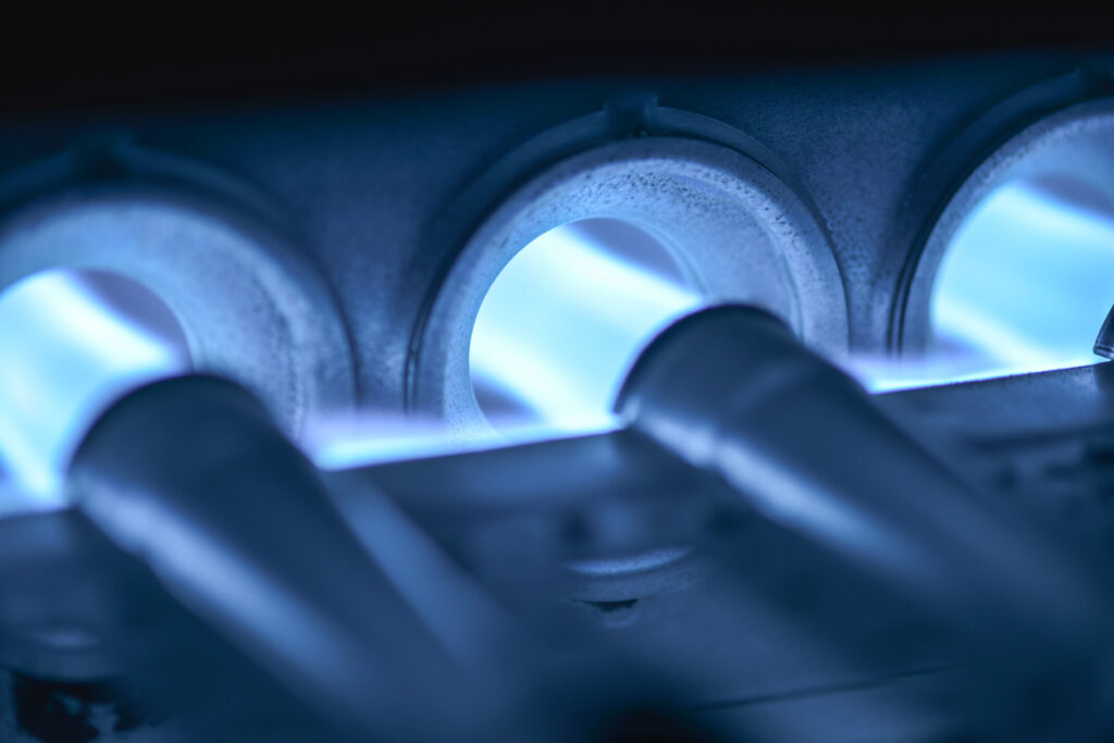 Closeup Shot Of Home Furnace Pilot Burners Ignited, burning blue